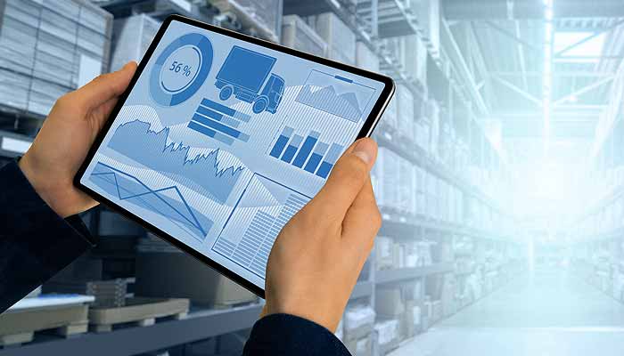 A manager with a tablet in a warehouse